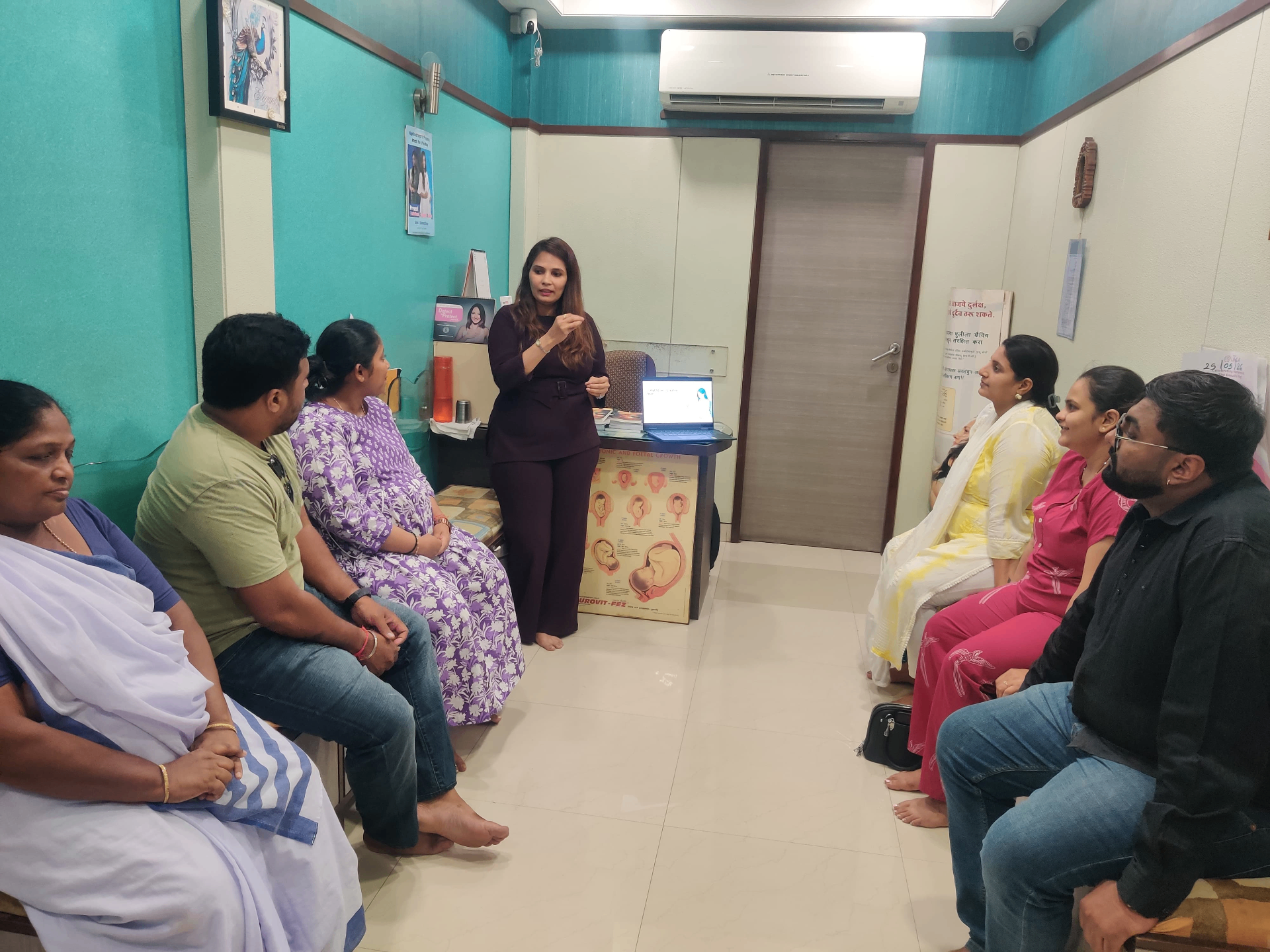 Bijall conducting a talk with expecting parents at a fertility clinic